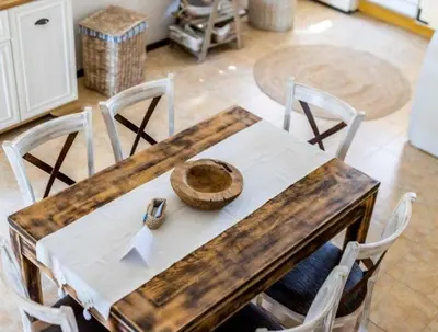 a wooden table with chairs and a white table cloth at The Pearl Of Lozenets in Lozenets
