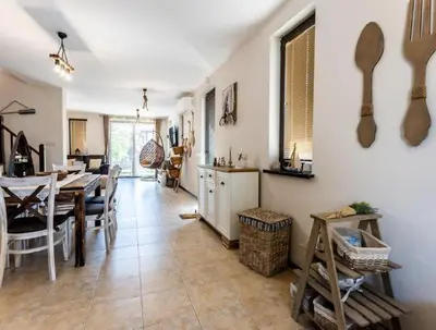 a kitchen and dining room with a table and chairs at The Pearl Of Lozenets in Lozenets