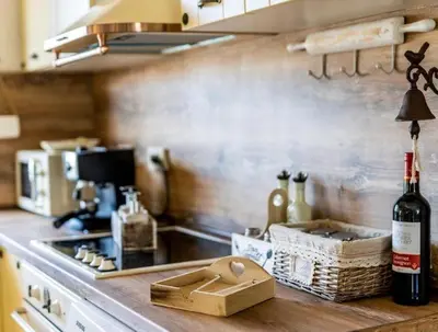 a kitchen with a counter with a bottle of wine at The Pearl Of Lozenets in Lozenets