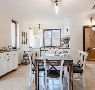 a kitchen with a table and chairs in a room at The Pearl Of Lozenets in Lozenets