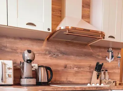 a kitchen with a coffeemaker on a kitchen counter at The Pearl Of Lozenets in Lozenets