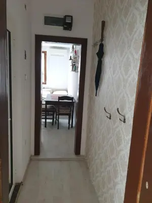 a hallway with a dining room with a table at Apartament Magi in Sozopol