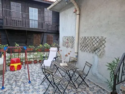 a patio with a table and chairs next to a building at Apartament Magi in Sozopol