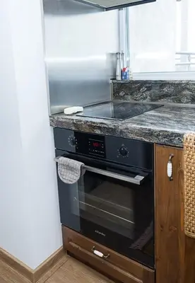 a black oven in a kitchen with a counter at Modern Comfort & Vintage Charm with Panoramic View by Flat Mаnаger in Varna City