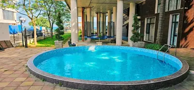 a swimming pool in front of a house at Amara Butik on the first line in Ravda