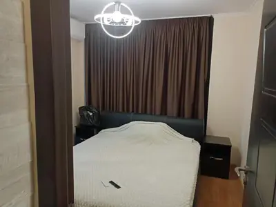 a bedroom with a bed and a chandelier at Amara Butik on the first line in Ravda
