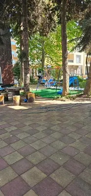 a park with a playground with trees and benches at Amara Butik on the first line in Ravda