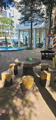 a picnic table with four stone benches around it at Amara Butik on the first line in Ravda