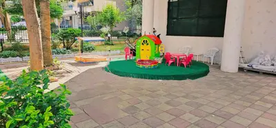 a playground with a toy house and red chairs at Amara Butik on the first line in Ravda