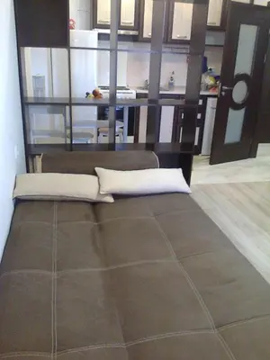 a bed in a room with a table at Родина- Rey&Mar Apartment in Sveti Vlas