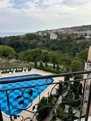 a view of a swimming pool from a balcony at Blue Bay Apartments in Byala