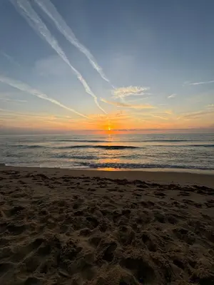 a sunset on a beach with the ocean at Blue Bay Apartments in Byala