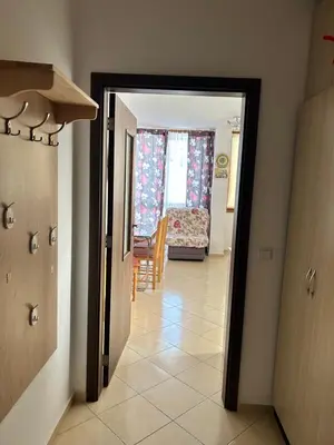 a hallway with a door leading to a living room at Апартамент в Риф 2 in Burgas City