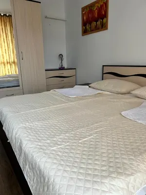 two beds sitting next to each other in a bedroom at Апартамент в Риф 2 in Burgas City