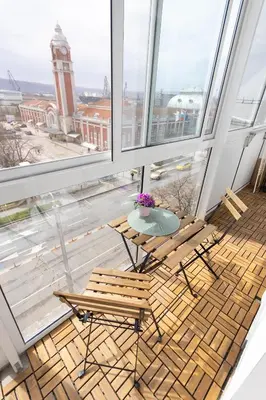 a balcony with a table and chairs and a view of a building at Green Dream Apart in Varna City