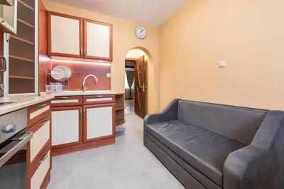 a living room with a couch in a kitchen at Downtown Аpartment with Free Parking in Varna City