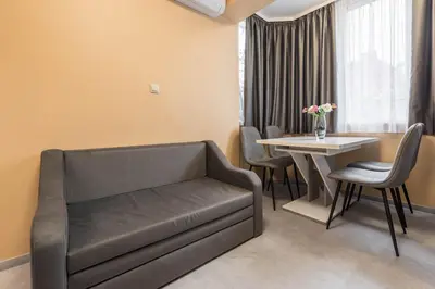 a living room with a couch and a table at Downtown Аpartment with Free Parking in Varna City
