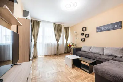 a living room with a couch and a television at Downtown Аpartment with Free Parking in Varna City
