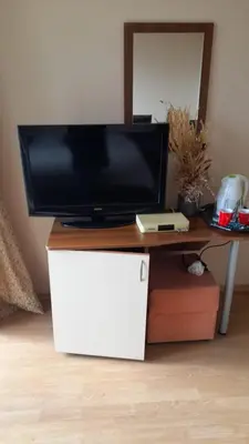 a tv sitting on top of a desk with a table at Guest House Sveti Vlas in Sveti Vlas