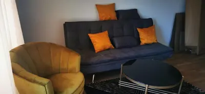 a living room with a couch and a chair at Nice 2 Bedroom Apartment with Sea and Poolview near Aheloy in Kableshkovo