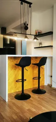 a kitchen with a counter with two bar stools at Nice 2 Bedroom Apartment with Sea and Poolview near Aheloy in Kableshkovo