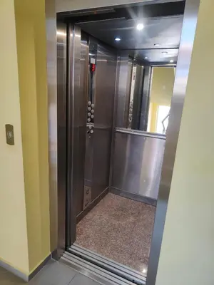 a elevator in a building with a mirror at Лукс Апартамент Морска Перла in Primorsko