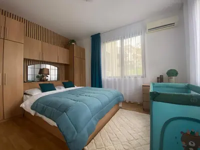 a bedroom with a large bed and a mirror at The Vineyard Spa&Resort Apartment with private garden near Aheloy in Kableshkovo