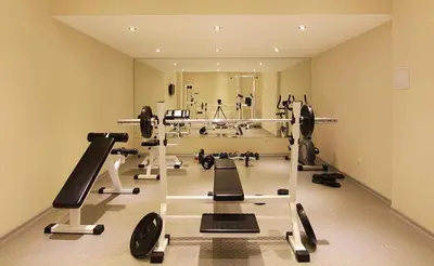 a gym with several treadmills and machines in a room at The Vineyard Spa&Resort Apartment with private garden near Aheloy in Kableshkovo