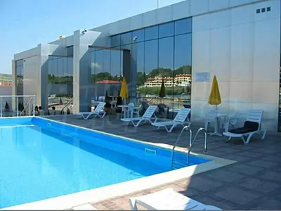a swimming pool on the roof of a building at Beach Front Luxurious Two Bedroom Apartment in Byala