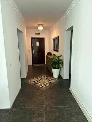a hallway with a plant in the middle of a room at Beach Front Luxurious Two Bedroom Apartment in Byala