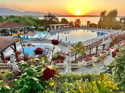 a view of a pool at a resort with a sunset at AJ Apartment 8, Santa Marina Holiday Village, Sozopol in Sozopol