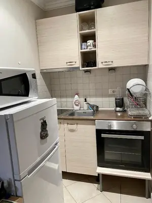 a small kitchen with a microwave and a stove at AJ Apartment 8, Santa Marina Holiday Village, Sozopol in Sozopol