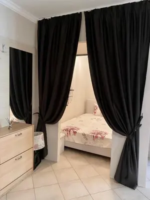 a bedroom with black curtains and a bed at AJ Apartment 8, Santa Marina Holiday Village, Sozopol in Sozopol