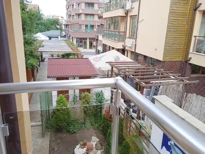 a balcony with a view of a street with buildings at Апартамент в непосредствена близост до плажа in Burgas City