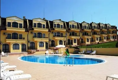 a person standing in front of a large building at Nessebar Apartment Pablo in Sunny Beach