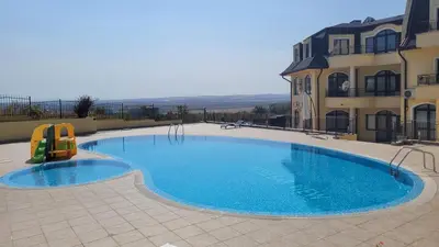 a large swimming pool in front of a building at Nessebar Apartment Pablo in Sunny Beach