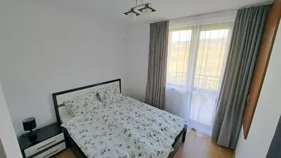 a bedroom with a bed and a window at Nessebar Apartment Pablo in Sunny Beach