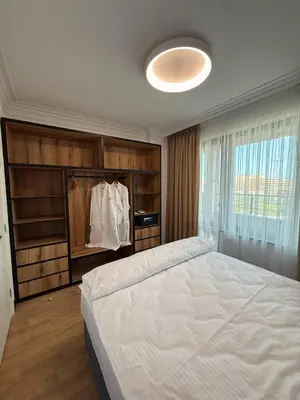 a bedroom with a large white bed and a window at Aparthotel Sveti Nikola in Pomorie