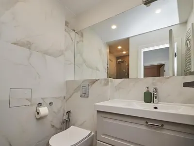 a white bathroom with a sink and a toilet at n17 Garden - Parking - WorkDesk - Blackout Rolls- Netflix - Wash&Dry in Burgas City