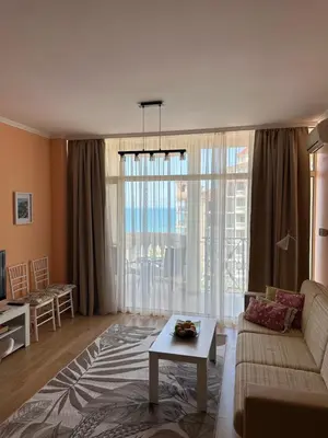 a living room with a couch and a table at 2 bedroom apartment komplex Andalusia Elenite with terrasa and sea in Sveti Vlas