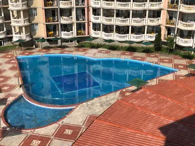 an empty swimming pool in front of a building at 2 bedroom apartment komplex Andalusia Elenite with terrasa and sea in Sveti Vlas