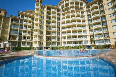 a swimming pool in front of a large apartment building at 2 bedroom apartment komplex Andalusia Elenite with terrasa and sea in Sveti Vlas