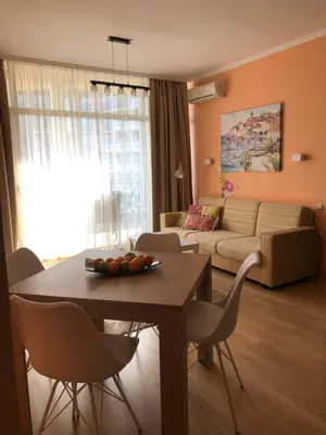 a living room with a table and a couch at 2 bedroom apartment komplex Andalusia Elenite with terrasa and sea in Sveti Vlas