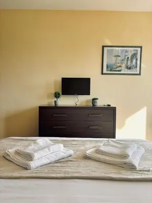 a bedroom with a bed with two towels on it at Sozopol Dreams Apart&FREE Parking in Sozopol
