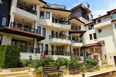 a building with benches in front of it at Sozopol Dreams Apart&FREE Parking in Sozopol