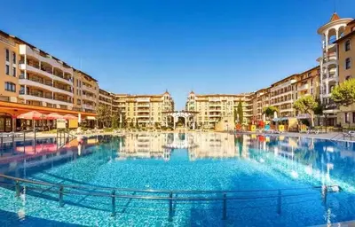 a large swimming pool in a city with buildings at Apartment at Royal Sun, Sunny Beach in Sunny Beach
