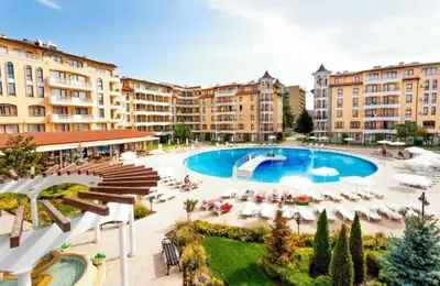a resort with a pool and chairs and buildings at Apartment at Royal Sun, Sunny Beach in Sunny Beach