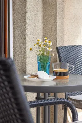 a table with a plate of food and a drink at Lidia Odrin by RV Apartments in Varna City
