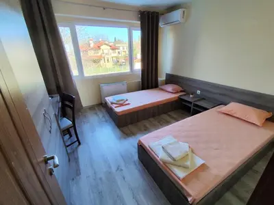 a small room with two beds and a window at Хостел Спортна база Ветрен in Burgas City