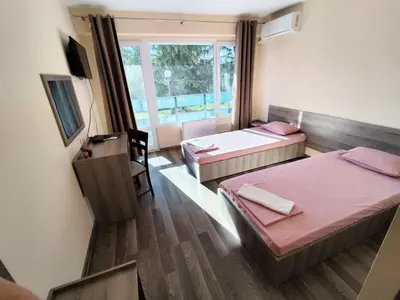 a room with two beds and a window at Хостел Спортна база Ветрен in Burgas City